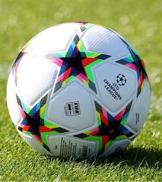 a soccer ball sitting on top of a lush green field