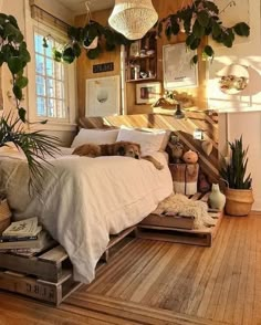 a bed room with a neatly made bed and lots of plants