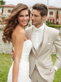 a man and woman in formal wear standing next to each other