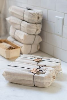 stacks of folded towels sitting on top of a white counter