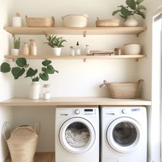 a washer and dryer sitting next to each other on top of a wooden shelf