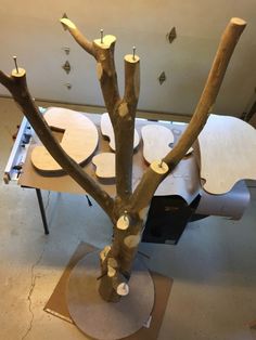 a table with several wooden discs on it and a tree made out of plywood