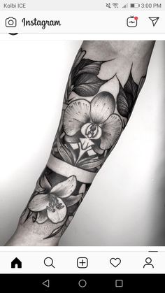 a black and white tattoo with flowers on the forearm, hand and armbands