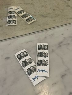 three stacks of money sitting on top of a counter next to each other with faces drawn on them