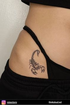 a woman with a scorpion tattoo on her stomach