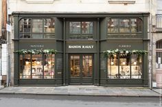 the exterior of a store called baron rault on a street corner in paris, france