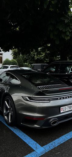 two cars parked in a parking lot next to each other