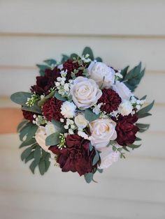 a bridal bouquet with red and white flowers