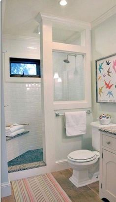 a bathroom with a toilet, sink and shower