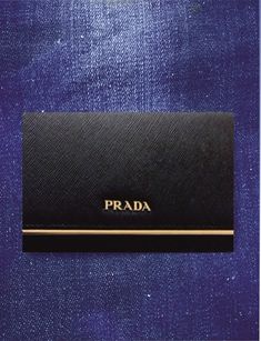 the prada card case is black and gold