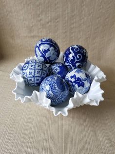 some blue and white eggs in a bowl