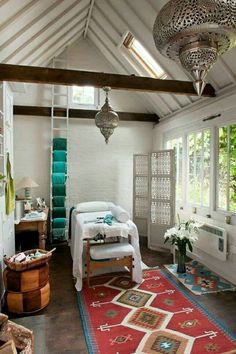 a bedroom with white walls and wooden floors has an area rug on the floor that matches the ceiling