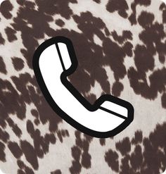 an animal print phone with the letter c on it's back side, in front of a brown and white background