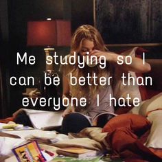 a woman sitting on top of a bed in front of a book shelf with books