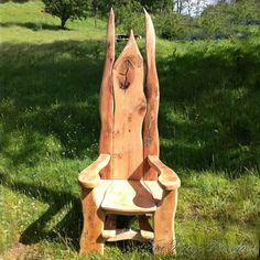 a wooden chair sitting in the grass