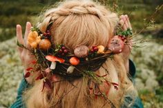 a woman with long blonde hair wearing a crown made of fruit and veggies