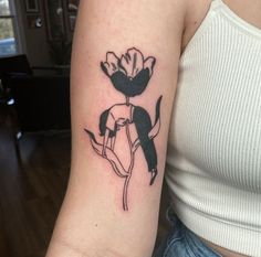 a woman's arm with a flower tattoo on it