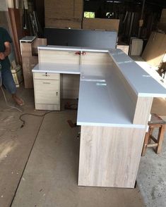 a man is working on an unfinished desk