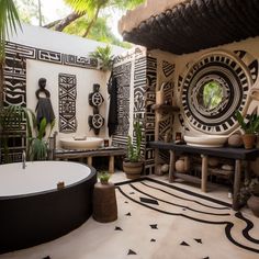 the bathroom is decorated with black and white tiles, potted plants, and an oval bathtub