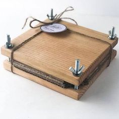 a small wooden box with screws attached to it