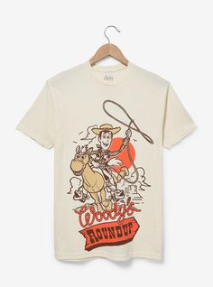 Get dressed up in wild west fashion with this Toy Story-inspired tee! Featuring a tonal portrait of Woody and Bullseye above "Woody's Roundup" lettering  this shirt is perfect for your next rodeo or trip to the Disney Parks.A BoxLunch Exclusive!100% cottonListed in unisex sizesWash cold with like colors; dry lowDo not iron over printImported Woody Birthday Shirt, Retro T-shirt For Western-themed Summer Events, Retro Summer T-shirt For Western-themed Events, Disney February, Woody And Bullseye, Wild West Fashion, Disneyland Fashion, Woody Birthday, Toy Story Gifts