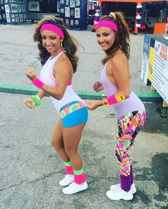 two women in colorful leggings and headbands are posing for the camera