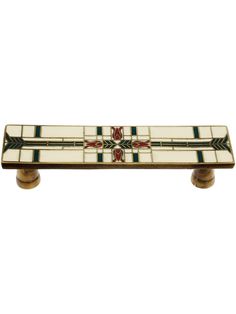 a white and green tile drawer pull with two handles on each side, in the shape of a cross