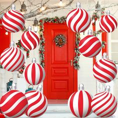 red and white ornaments are hanging from the front door