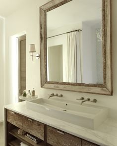 a bathroom with a large mirror above the sink