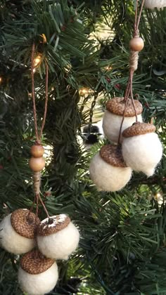 three ornaments hanging from the branches of a christmas tree