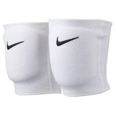 two white knee pads with black nike logo