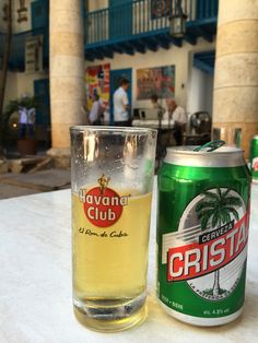 a can of corona club and a glass on a table