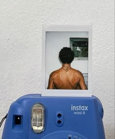 an instax mini 9 camera with the image of a man on it