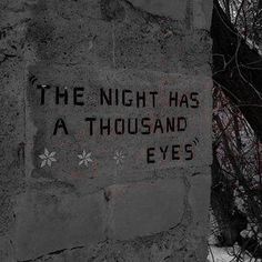 a cement sign that says the night has a thousand eyes