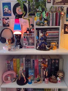 a book shelf filled with books and figurines on top of it's shelves