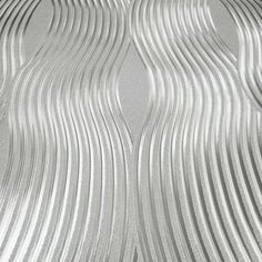 an abstract silver background with wavy lines in the shape of waves on top of each other