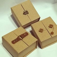 three wooden boxes sitting on top of a white table