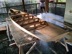 a wooden boat being built in a building