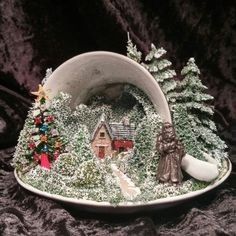 a white bowl filled with snow covered houses and trees