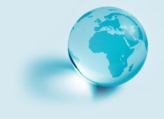 an image of a glass globe on a blue background with the shadow of the earth