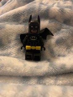 a lego batman laying on top of a blanket