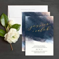 wedding stationery with white flowers and greenery