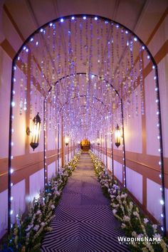 an archway decorated with lights and flowers