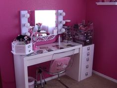 a white desk topped with a pink vanity