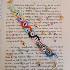 an open book with letters and numbers on it's pages, surrounded by confetti