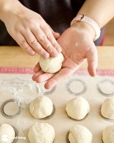 a person is kneading dough into small balls