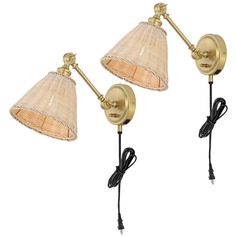 two wall lights with shades on each side and one light attached to the back of it