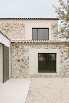 an exterior view of a house with two garages