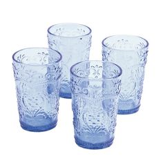 four blue glass tumblers sitting next to each other