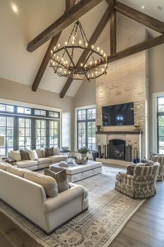 a large living room with couches, chairs and a tv mounted on the wall